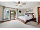 Spacious main bedroom features a ceiling fan and access to the outside deck through french doors at 19640 Four Winds Way, Monument, CO 80132