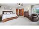 Spacious main bedroom features a ceiling fan, generous natural light and a luxurious recliner at 19640 Four Winds Way, Monument, CO 80132