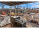 Cozy backyard features a covered patio with a modern fire pit and seating, plus a shed and swing set in the background at 3075 N Elm Ave, Denver, CO 80207