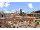 Backyard features a rock patio with seating and a garden area, offering a private and tranquil outdoor space at 3075 N Elm Ave, Denver, CO 80207