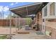 Backyard patio with covered area, rocking chair, and exterior door provide a relaxing outdoor living space at 3075 N Elm Ave, Denver, CO 80207