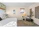 Bright bedroom with decorative wall hangings, plush carpet, and comfortable seating area at 3075 N Elm Ave, Denver, CO 80207