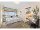 Bright bedroom featuring a floral accent wall, plush carpet, and comfortable seating area at 3075 N Elm Ave, Denver, CO 80207