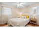 Bright bedroom featuring two windows with white walls, hardwood floors, and modern decor at 3075 N Elm Ave, Denver, CO 80207
