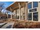 Contemporary building exterior featuring modern architecture, large windows and a stylish trellis wine bar sign at 3075 N Elm Ave, Denver, CO 80207