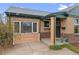 Charming brick home featuring a welcoming front entrance, flower box and freshly landscaped accents at 3075 N Elm Ave, Denver, CO 80207