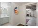 Hallway that connects an updated bathroom to the basement at 3075 N Elm Ave, Denver, CO 80207
