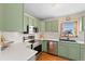 Modern kitchen with stainless appliances, white countertops, and hardwood floors at 3075 N Elm Ave, Denver, CO 80207