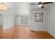 Sun-lit living room with hardwood floors and a large window at 3075 N Elm Ave, Denver, CO 80207