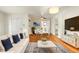 Bright living room with an open floorplan, hardwood floors, couch, and modern decor at 3075 N Elm Ave, Denver, CO 80207