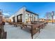 Outdoor patio with wooden picnic tables and a view of the building at 3075 N Elm Ave, Denver, CO 80207