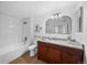 Bright bathroom featuring updated vanity, granite countertop, subway tile shower, and wood-look flooring at 9590 E Florida Ave # 1025, Denver, CO 80247