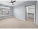 Bedroom with carpet and a large window; includes a walk-in closet with shelving at 9590 E Florida Ave # 1025, Denver, CO 80247