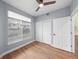 Bedroom with wood-look floors, ceiling fan, large window and closet doors at 9590 E Florida Ave # 1025, Denver, CO 80247