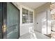 Welcoming front entryway featuring a storm door, window for natural light, and convenient access to storage at 9590 E Florida Ave # 1025, Denver, CO 80247