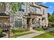 Beautiful townhome featuring stone accents, manicured lawns, and well-kept landscaping; a true gem at 9590 E Florida Ave # 1025, Denver, CO 80247