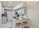 Cozy kitchen with breakfast bar, stylish stools, and stainless steel appliances at 9590 E Florida Ave # 1025, Denver, CO 80247