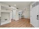 Open-concept living space with wood floors, a breakfast bar and modern light fixture at 9590 E Florida Ave # 1025, Denver, CO 80247