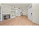 Inviting living room with fireplace, wood flooring, and access to the kitchen at 9590 E Florida Ave # 1025, Denver, CO 80247