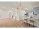 Spacious living area connects to kitchen, featuring a fireplace and breakfast bar at 9590 E Florida Ave # 1025, Denver, CO 80247