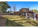 Expansive backyard with lush green lawn, mature trees, and outdoor living spaces at 4468 S Zenobia St, Denver, CO 80236