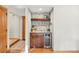 Stylish bar area with a wine cooler and elegant shelving, perfect for entertaining guests at 4468 S Zenobia St, Denver, CO 80236