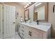 Bathroom with a double vanity, white marble countertop, and modern black fixtures at 4468 S Zenobia St, Denver, CO 80236