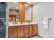 Bathroom boasts a double vanity with quartz countertops, wood cabinets, and modern fixtures at 4468 S Zenobia St, Denver, CO 80236