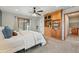 Bright bedroom featuring built-in wood shelving, ceiling fan, and sliding door with natural light at 4468 S Zenobia St, Denver, CO 80236