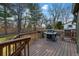 Spacious wooden deck with grill, stairs, and a view of the backyard at 4468 S Zenobia St, Denver, CO 80236