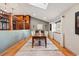 Bright dining room with hardwood floors, a modern rug, and ample natural light, adjacent to a well-appointed kitchen at 4468 S Zenobia St, Denver, CO 80236