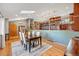 Open-concept dining room featuring hardwood floors, a skylight, and seamless flow to the kitchen at 4468 S Zenobia St, Denver, CO 80236