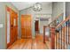 Elegant foyer with hardwood floors, a staircase with iron railings, and a stylish light fixture, creating a welcoming entrance at 4468 S Zenobia St, Denver, CO 80236