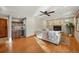 Inviting living room featuring a stone fireplace, hardwood floors, and a stylish bar area at 4468 S Zenobia St, Denver, CO 80236