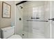 Modern bathroom featuring a glass-enclosed shower with tiled walls and a rainfall showerhead at 4468 S Zenobia St, Denver, CO 80236