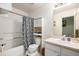 Cozy bathroom featuring a shower-tub combination with patterned curtain and sink with cabinet at 1655 S Buckley Cir, Aurora, CO 80017