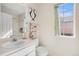 Bright bathroom featuring a vanity with a clean white countertop and a view to the outside at 1655 S Buckley Cir, Aurora, CO 80017