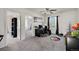 Sunlit bedroom with a dedicated workspace, ceiling fan, and view to an adjacent room at 1655 S Buckley Cir, Aurora, CO 80017