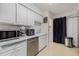 Bright kitchen with stainless steel appliances and white cabinets provides a clean and modern space at 1655 S Buckley Cir, Aurora, CO 80017