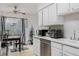 Bright kitchen featuring white cabinets, stainless steel appliances, and a dining area with a view at 1655 S Buckley Cir, Aurora, CO 80017