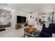 Open-concept living room with modern decor, comfortable seating, and adjacent dining area at 1655 S Buckley Cir, Aurora, CO 80017