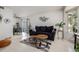 Cozy living room with neutral tones, a plush sofa, and a view into the dining area at 1655 S Buckley Cir, Aurora, CO 80017