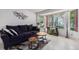 Cozy living room featuring a dark sofa, natural light, and decorative accents at 1655 S Buckley Cir, Aurora, CO 80017