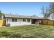 Spacious backyard with lush lawn, surrounded by wooden fences for privacy at 5780 W 5Th Ave, Lakewood, CO 80226