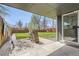 Covered patio space with brick accents and a view of the freshly cut lawn at 5780 W 5Th Ave, Lakewood, CO 80226