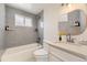 Stylish bathroom with gray tile, modern fixtures, and a soaking tub at 5780 W 5Th Ave, Lakewood, CO 80226
