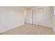 Bright bedroom with light wood flooring features a closet and white trim at 5780 W 5Th Ave, Lakewood, CO 80226