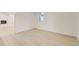 Finished basement bedroom with wood-look floors, a window, and access to another room at 5780 W 5Th Ave, Lakewood, CO 80226