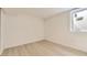 Neutral bedroom with window and wood-look flooring at 5780 W 5Th Ave, Lakewood, CO 80226
