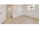 Bright bedroom features light wood floors, white trim, a closet, and a window at 5780 W 5Th Ave, Lakewood, CO 80226
